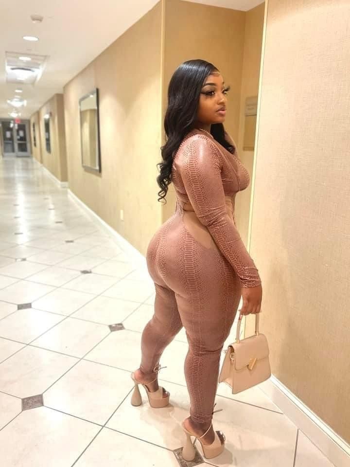 Thick curvy woman in fitted outfit with confident pose