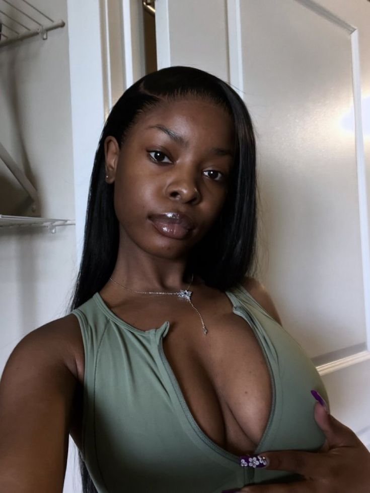 Thick curvy woman in fitted blue dress posing confidently