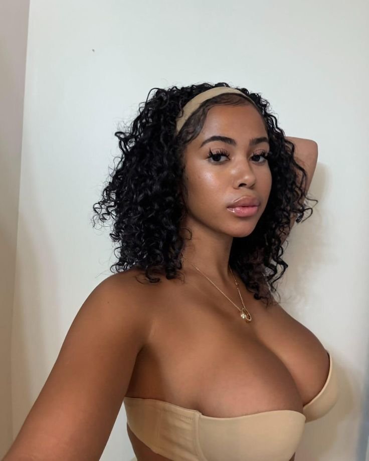 Soft curvy UK phone chat model Irelia Moon with natural curls and calm confident presence