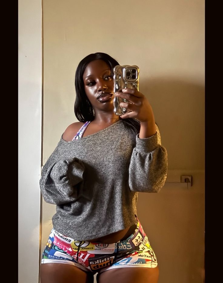 Thick curvy UK phone chat model Kymora Dax with relaxed street style and confident presence