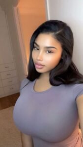 Soft-glam curvy woman indoors representing phone sex chat UK and adult chat with horny girls