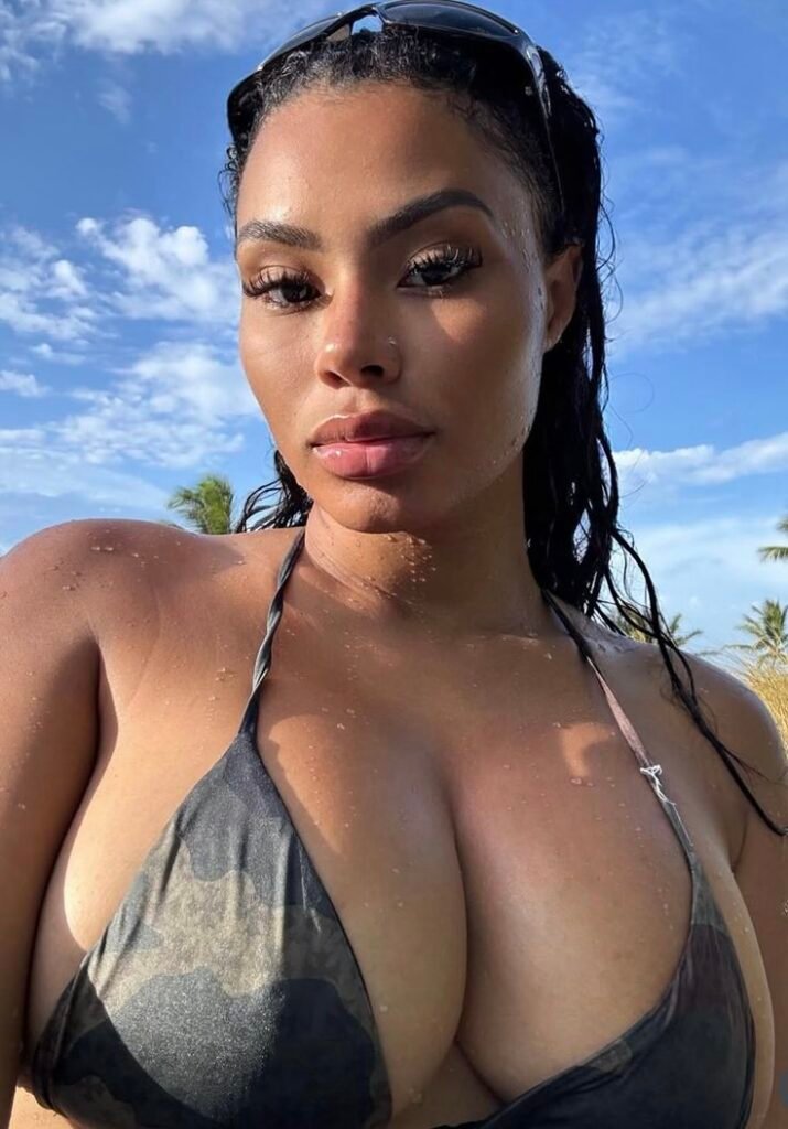 Confident curvy woman wearing a bikini top outdoors with sun-kissed skin and wet hair