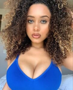 Confident woman with curly hair representing phone sex chat UK and adult chat with horny girls