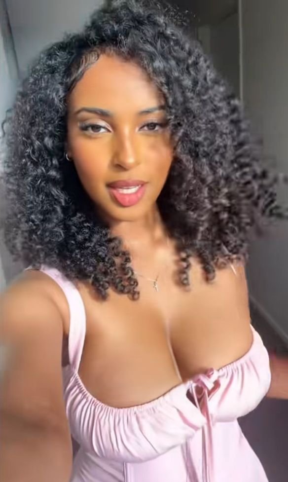 Soft curvy UK phone chat model Lunara Blyss with natural curls and warm confident presence