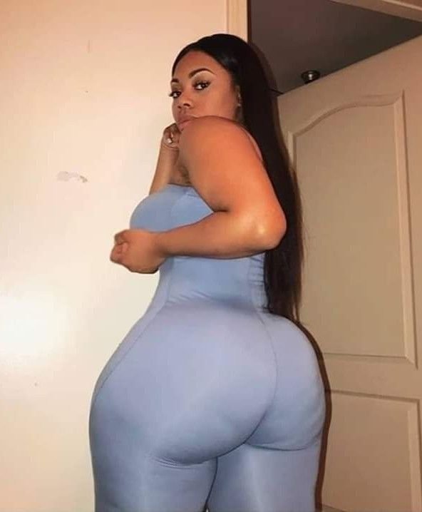 Thick curvy UK phone chat model Kavira Solenn with long sleek hair and confident side-profile pose