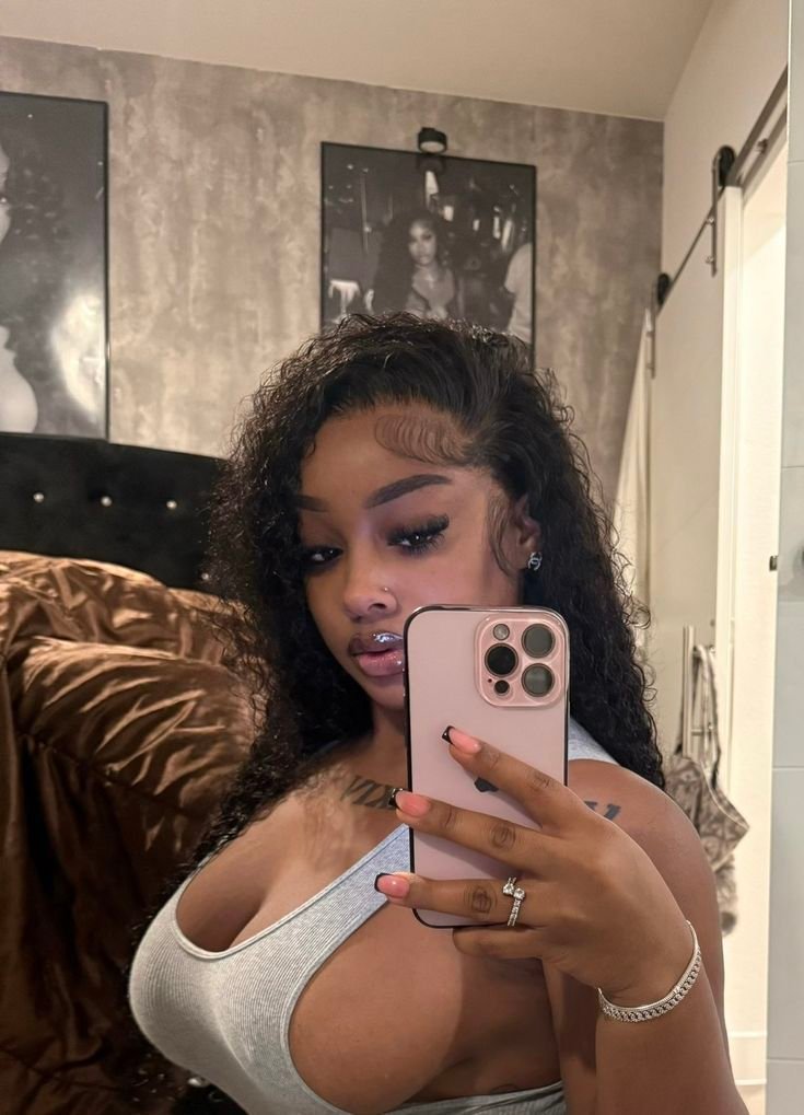 Intimate curvy UK phone chat model Serenique Vale with soft curls and confident presence indoors