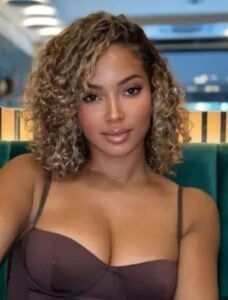 Elegant curvy woman seated indoors representing phone sex chat UK and adult chat with horny girls