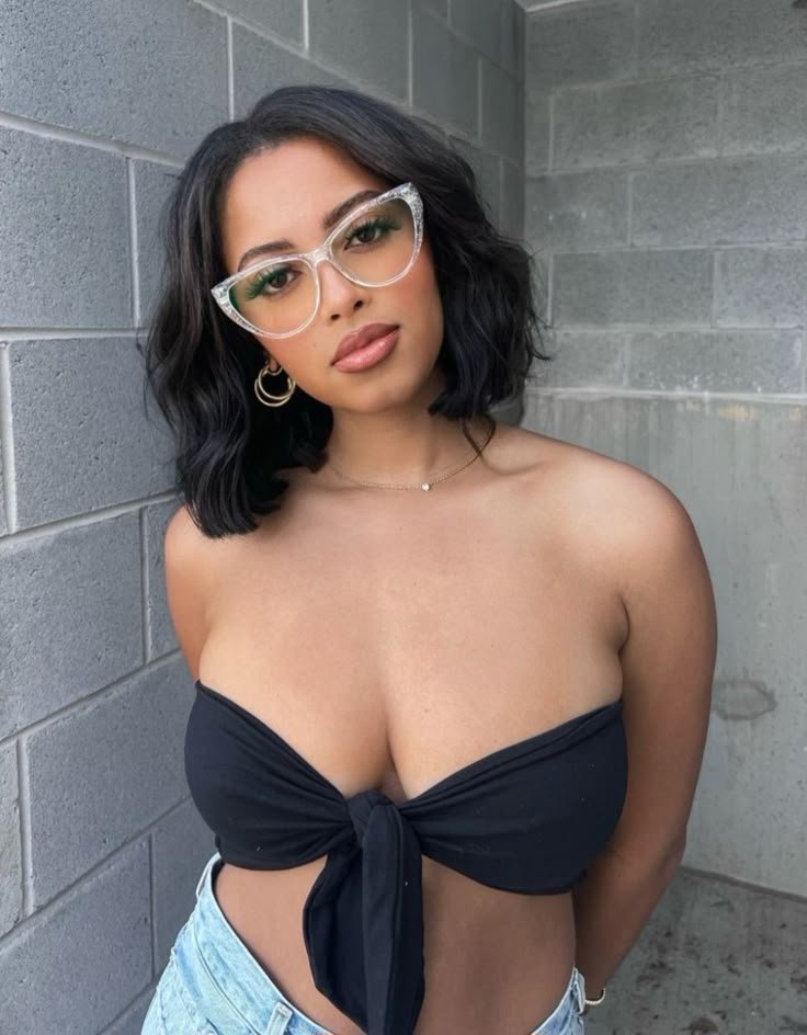 Confident woman wearing glasses representing phone sex chat UK and adult chat with horny girls