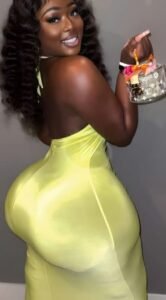 Thick curvy woman in bright fitted dress smiling confidently