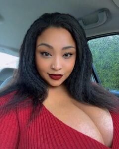 Confident curvy woman in a car selfie representing phone sex chat UK and adult chat with horny girls