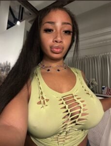 Flirty UK phone chat model Alinaya Rose with freckles, long dark hair, and playful confident energy