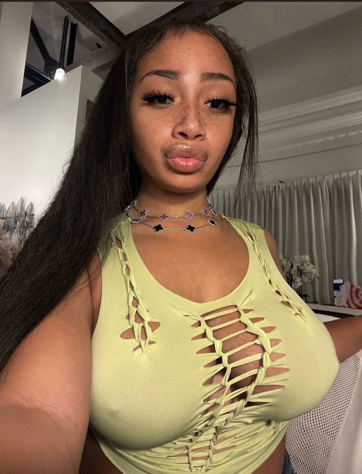 Flirty UK phone chat model Alinaya Rose with freckles, long dark hair, and playful confident energy