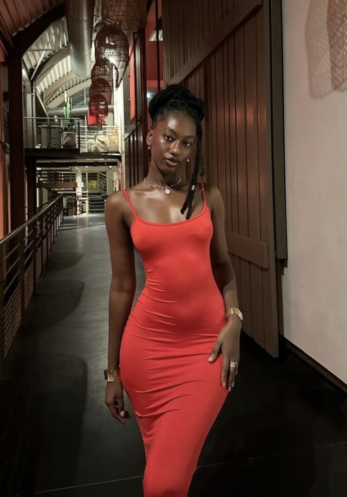 Confident woman in a fitted red dress representing UK phone sex chat and adult chat