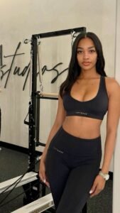 Athletic confident woman in gym wear representing UK phone sex chat and adult chat