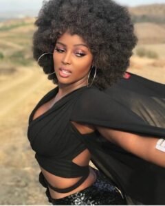 Confident woman posing in neutral-toned lingerie with a poised and elegant look