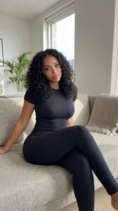 Confident woman sitting on a sofa representing phone sex chat UK and adult chat with horny girls