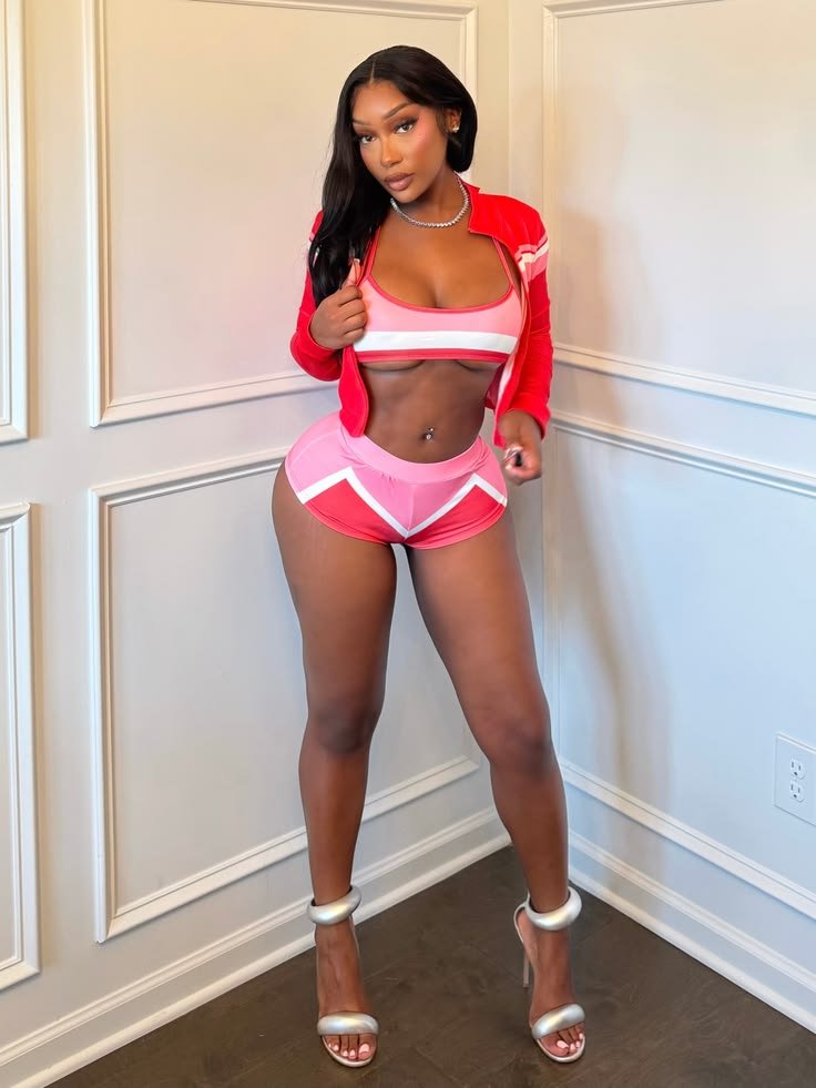 Confident FemDom companion wearing stylish red and pink outfit Curvy fetish chat profile portrait Fashionable dominant woman with long black hair Premium FemDom profile image Athletic curvy companion profile photo Stylish adult chatline profile picture