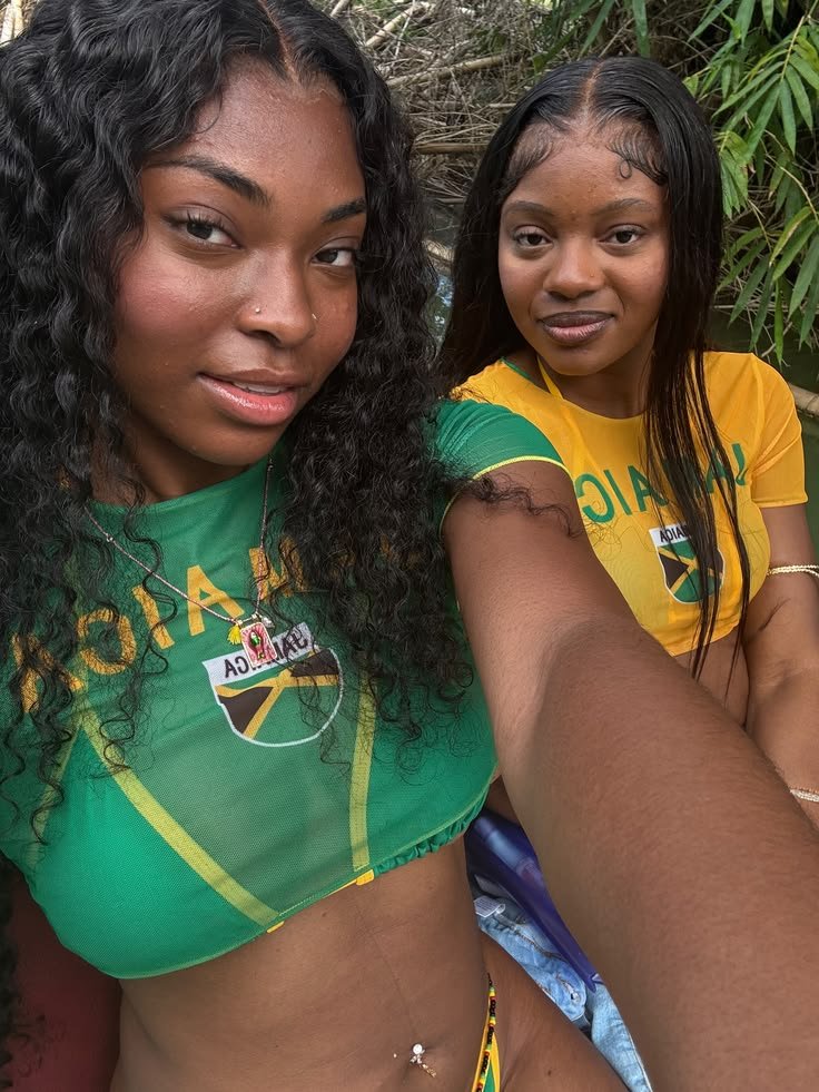 Girls on girls chat UK profile featuring two women in Jamaica-inspired outfits Lesbian phone chat UK female duo with coordinated casual fashion Women seeking women chat profile with tropical style Girls on girls phone chat UK profile image Lesbian chat lines UK confident female pair Adult chat UK girls on girls category profile