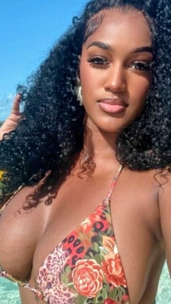Luxury FemDom companion with long natural curly hair Confident woman in floral bikini top Premium fetish phone chat profile image Elegant dominant female companion portrait Curvy fantasy chat companion profile Glamorous FemDom profile photograph Premium adult chatline companion image Stylish luxury fantasy companion portrait