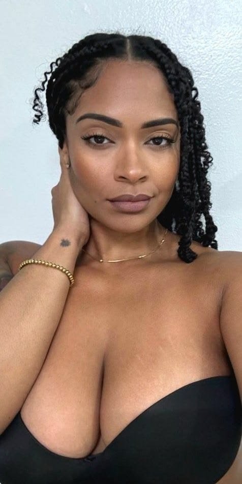 Elegant FemDom companion with natural twist braids Confident woman with sophisticated natural beauty Premium fetish phone chat profile image Curvy dominant female companion portrait Glamorous FemDom profile photograph Premium fantasy companion with elegant style Modern adult chatline profile picture