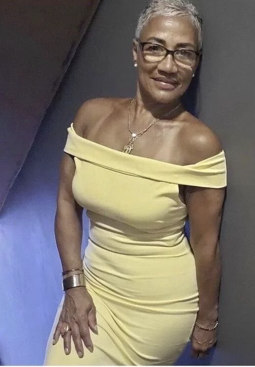 Granny phone sex UK profile featuring elegant mature woman Phone sex grannies UK with short silver pixie hairstyle Mature granny phone chat profile in yellow off-shoulder dress