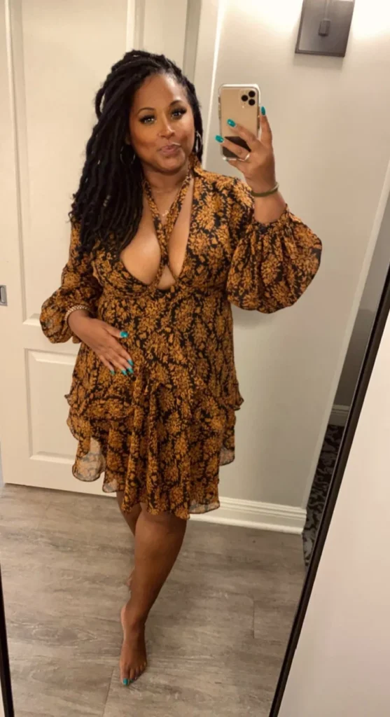 Granny phone sex UK profile featuring mature woman with long locs Phone sex grannies UK in patterned wrap dress