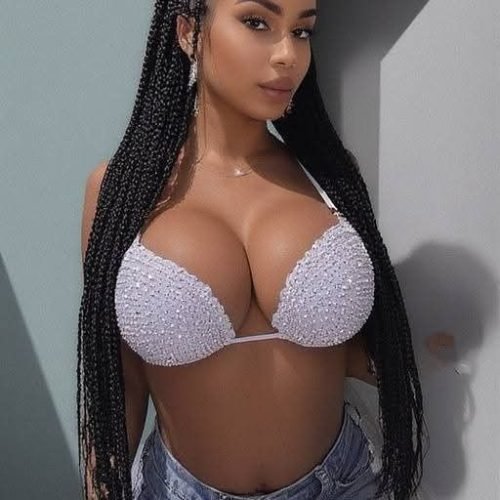 Glam curvy UK phone chat model Naelani Virex with long braids and confident presence