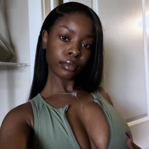 Thick curvy woman in fitted blue dress posing confidently