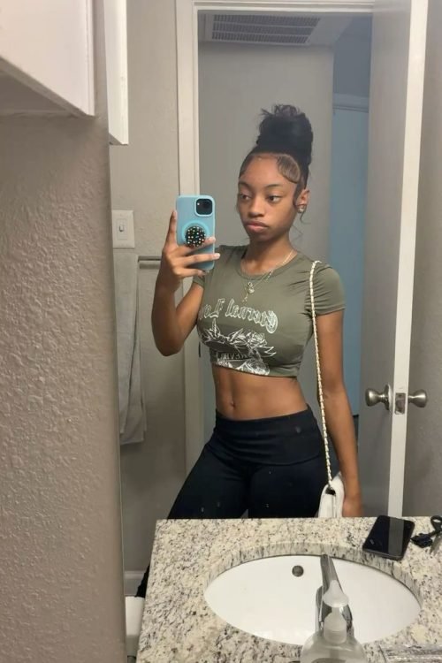Confident woman taking a mirror selfie representing phone sex chat UK and adult chat