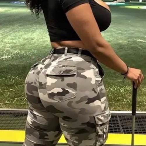 Confident curvy woman at a driving range representing phone sex chat UK and adult chat with horny girls