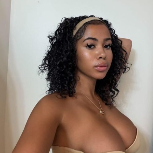 Soft curvy UK phone chat model Irelia Moon with natural curls and calm confident presence