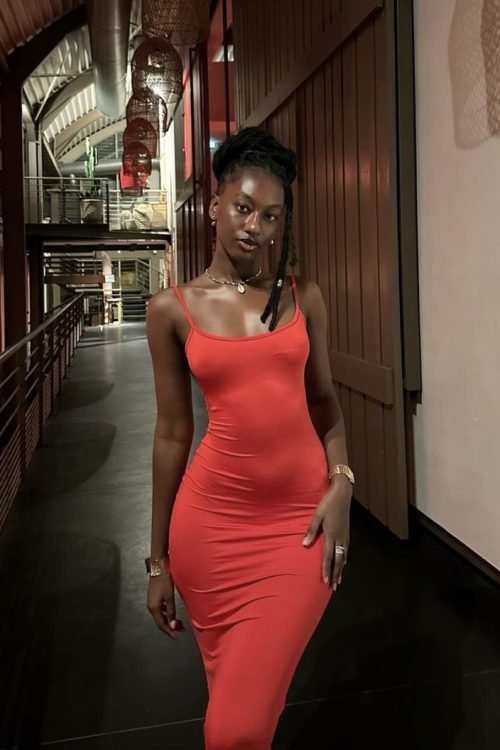 Confident woman in a fitted red dress representing UK phone sex chat and adult chat