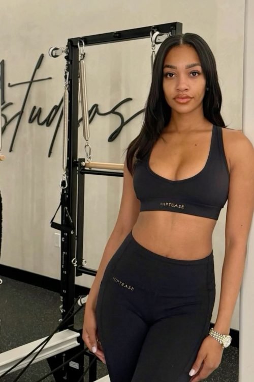 Athletic confident woman in gym wear representing UK phone sex chat and adult chat