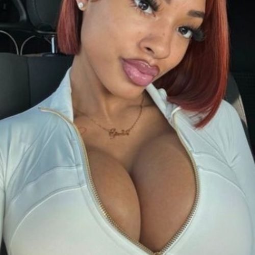 Flirty curvy UK phone chat model Aria Novelle with auburn bob and confident presence