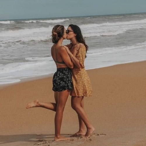 Girls on girls chat UK profile featuring two women on the beach Lesbian phone chat UK female couple by the ocean Women seeking women chat profile in a seaside setting Girls on girls phone chat UK beach profile image Lesbian chat lines UK confident female duo Adult chat UK girls on girls category profile