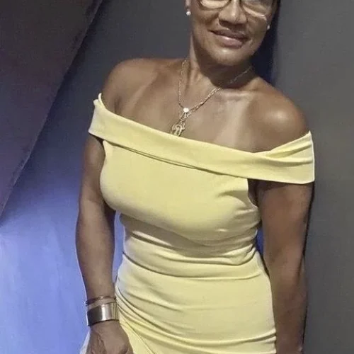 Granny phone sex UK profile featuring elegant mature woman Phone sex grannies UK with short silver pixie hairstyle Mature granny phone chat profile in yellow off-shoulder dress