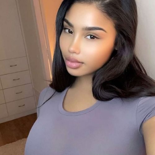 Soft-glam curvy woman indoors representing phone sex chat UK and adult chat with horny girls