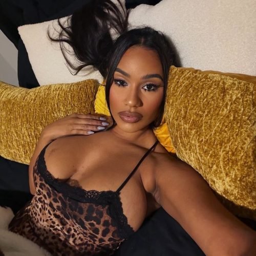 Intimate curvy UK phone chat model Zalina Noire reclining in leopard print with confident gaze