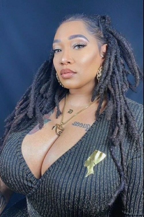 Confident curvy UK phone chat model Zarielle Noire with styled locs and elegant commanding presence