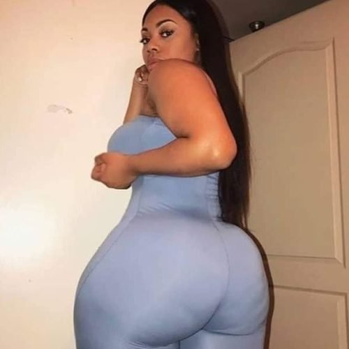 Thick curvy UK phone chat model Kavira Solenn with long sleek hair and confident side-profile pose