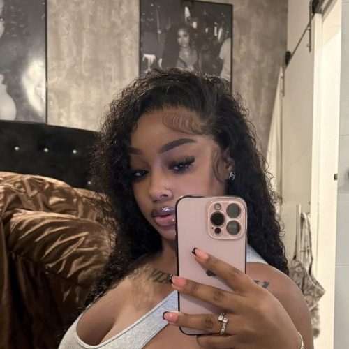 Intimate curvy UK phone chat model Serenique Vale with soft curls and confident presence indoors