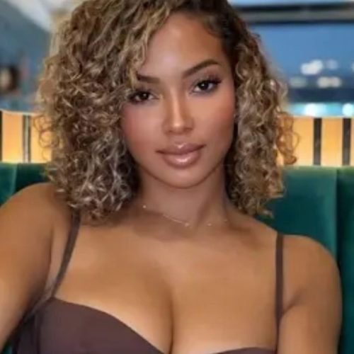 Elegant curvy woman seated indoors representing phone sex chat UK and adult chat with horny girls