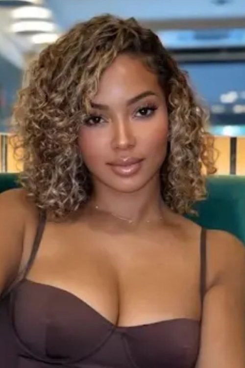 Elegant curvy woman seated indoors representing phone sex chat UK and adult chat with horny girls