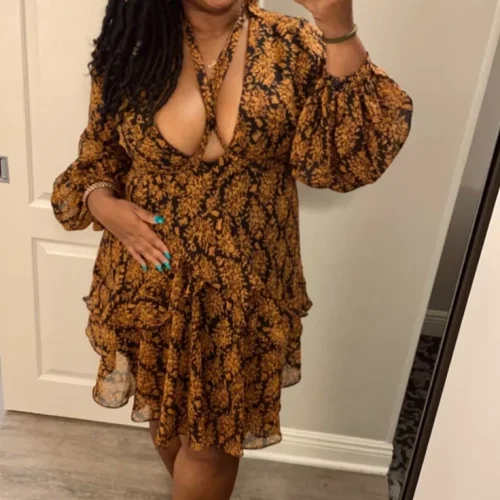 Granny phone sex UK profile featuring mature woman with long locs Phone sex grannies UK in patterned wrap dress