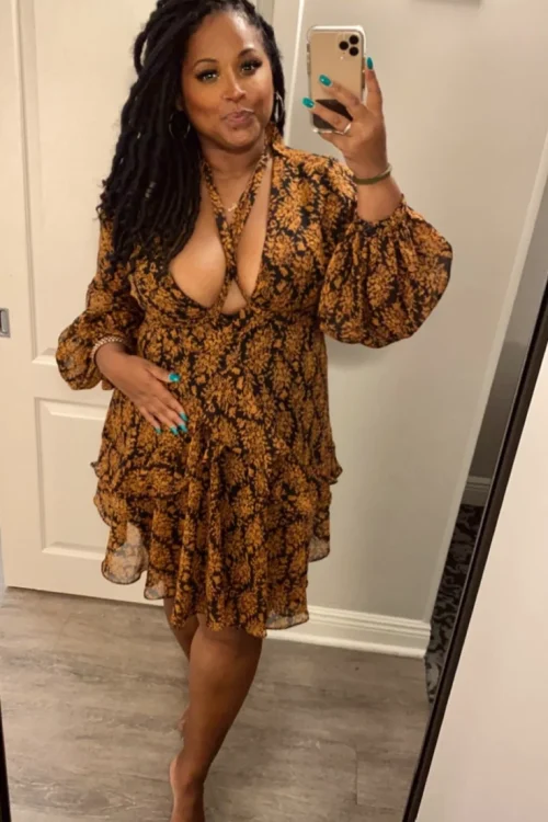 Granny phone sex UK profile featuring mature woman with long locs Phone sex grannies UK in patterned wrap dress