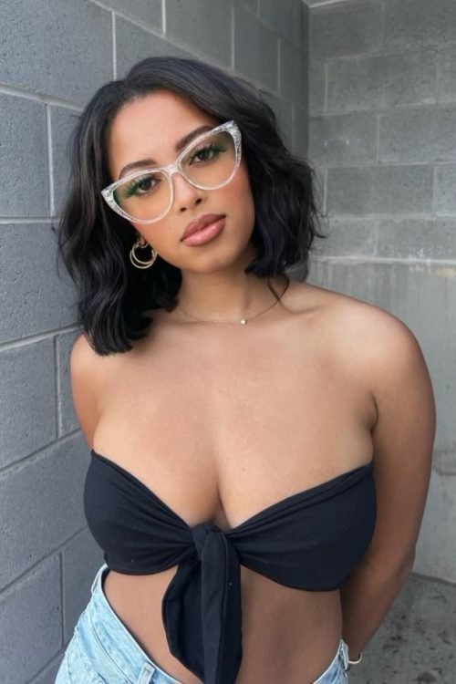 Confident woman wearing glasses representing phone sex chat UK and adult chat with horny girls