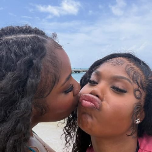 Girls on girls chat UK profile featuring two women at the beach Lesbian phone chat UK female duo with natural curly hair Women seeking women chat profile with playful expressions Girls on girls phone chat UK profile image Lesbian chat lines UK confident female pair