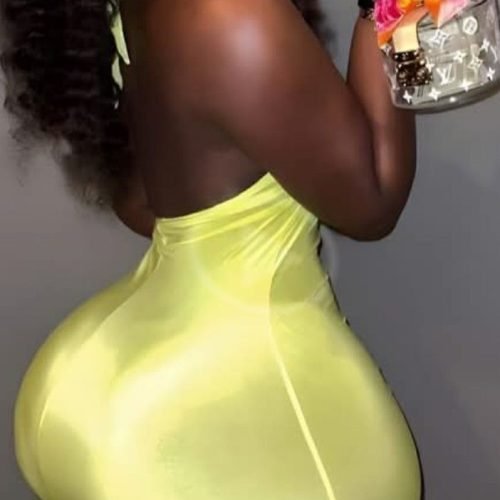 Thick curvy woman in bright fitted dress smiling confidently