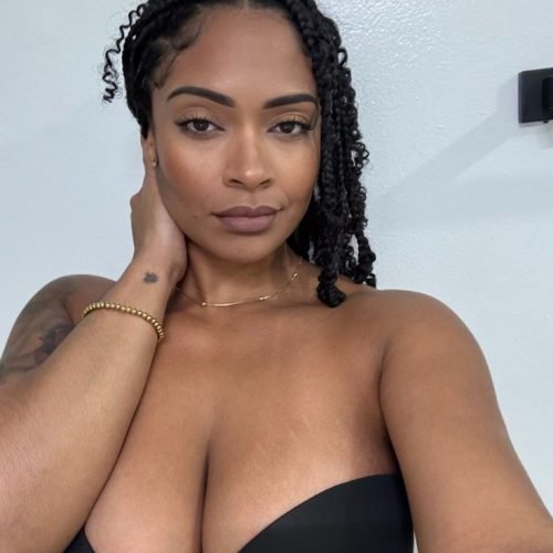 Calm curvy UK phone chat model Aureya Calmyn with natural braids and confident presence