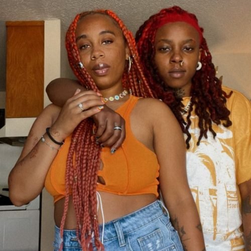 Girls on girls chat UK profile featuring two confident women Lesbian phone chat UK female duo with braided hairstyles Women seeking women chat profile in casual streetwear Girls on girls phone chat UK profile image Lesbian chat lines UK confident female pair Adult chat UK girls on girls category profile Live girls on girls chat featuring stylish women